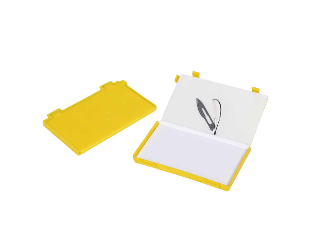 Puncture Proof Pad | Labs Choice Puncture Proof Pad features a rigid, puncture-resistant plastic construction designed to help organize, count, and dispose of contaminated needles, blades, and sutures. A wide adhesive strip secures sharps in place, while the locking mechanism and overlapping edges help prevent accidental opening and sharps migration. | Labs Choice
